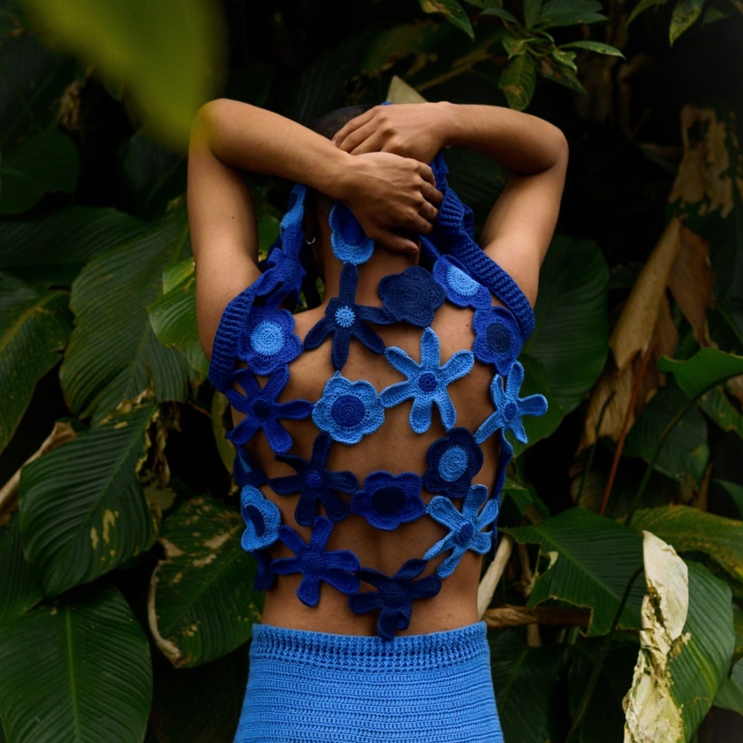 Stunning handmade crochet vest with blue floral accents, perfect for adding an artisanal touch to your wardrobe.