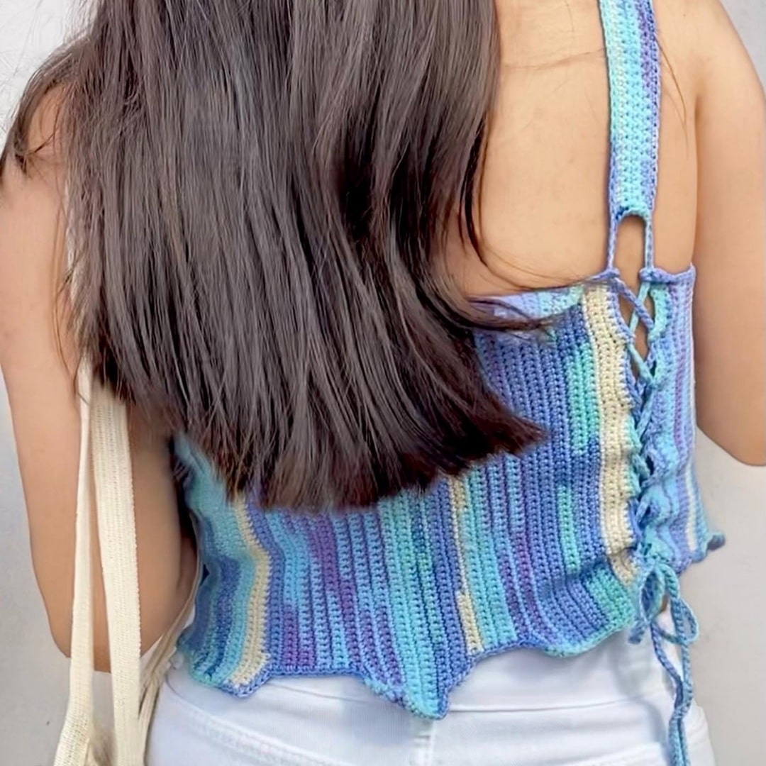 Back view of Blue Stroke crochet top – detailed lace-up pattern for a snug fit.