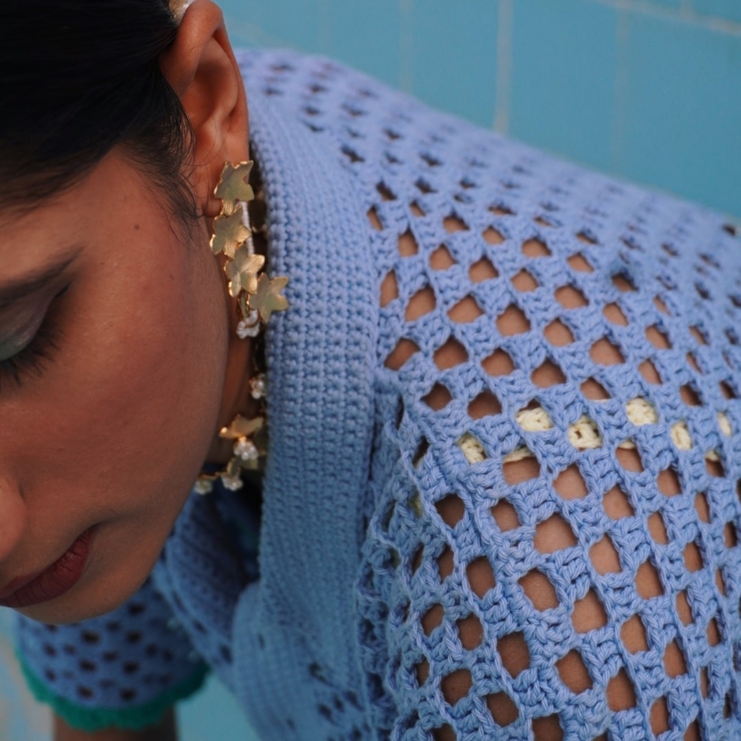 Detailed crochet work of the Peekaboo Shirt showcasing intricate hand-stitched open patterns.