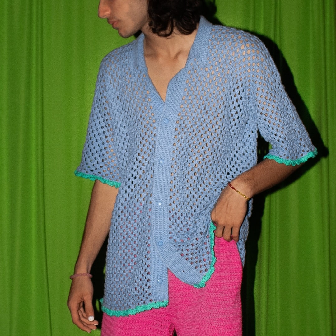 Model wearing the unisex Peekaboo Crochet Shirt, highlighting its versatility.
