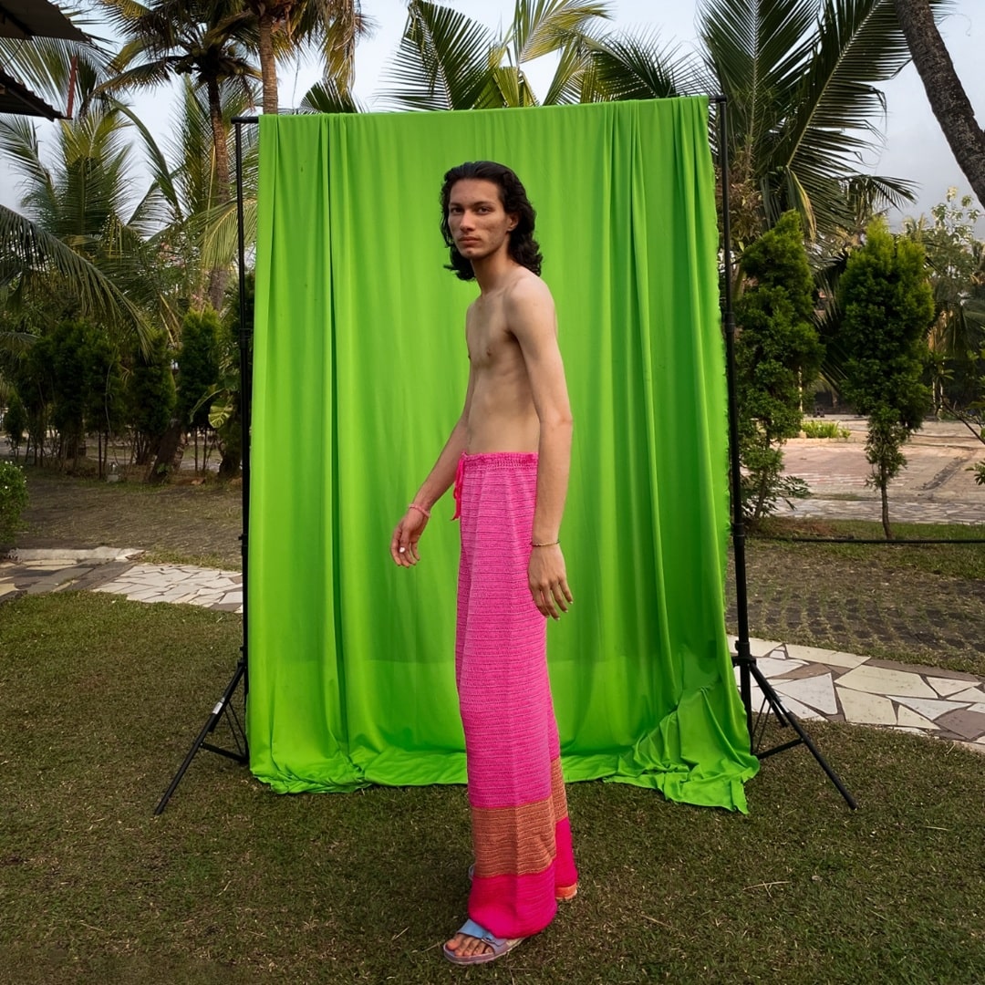 Side view of Pink Fluorite crochet pants showcasing the monochromatic color and fit.