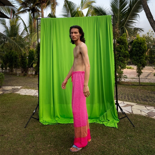 Side view of Pink Fluorite crochet pants showcasing the monochromatic color and fit.