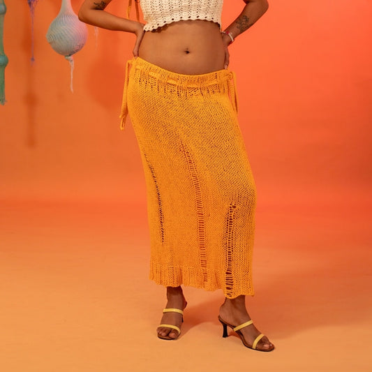 Front view of the Citrus knit skirt, showcasing its breezy orange hue and handcrafted details.