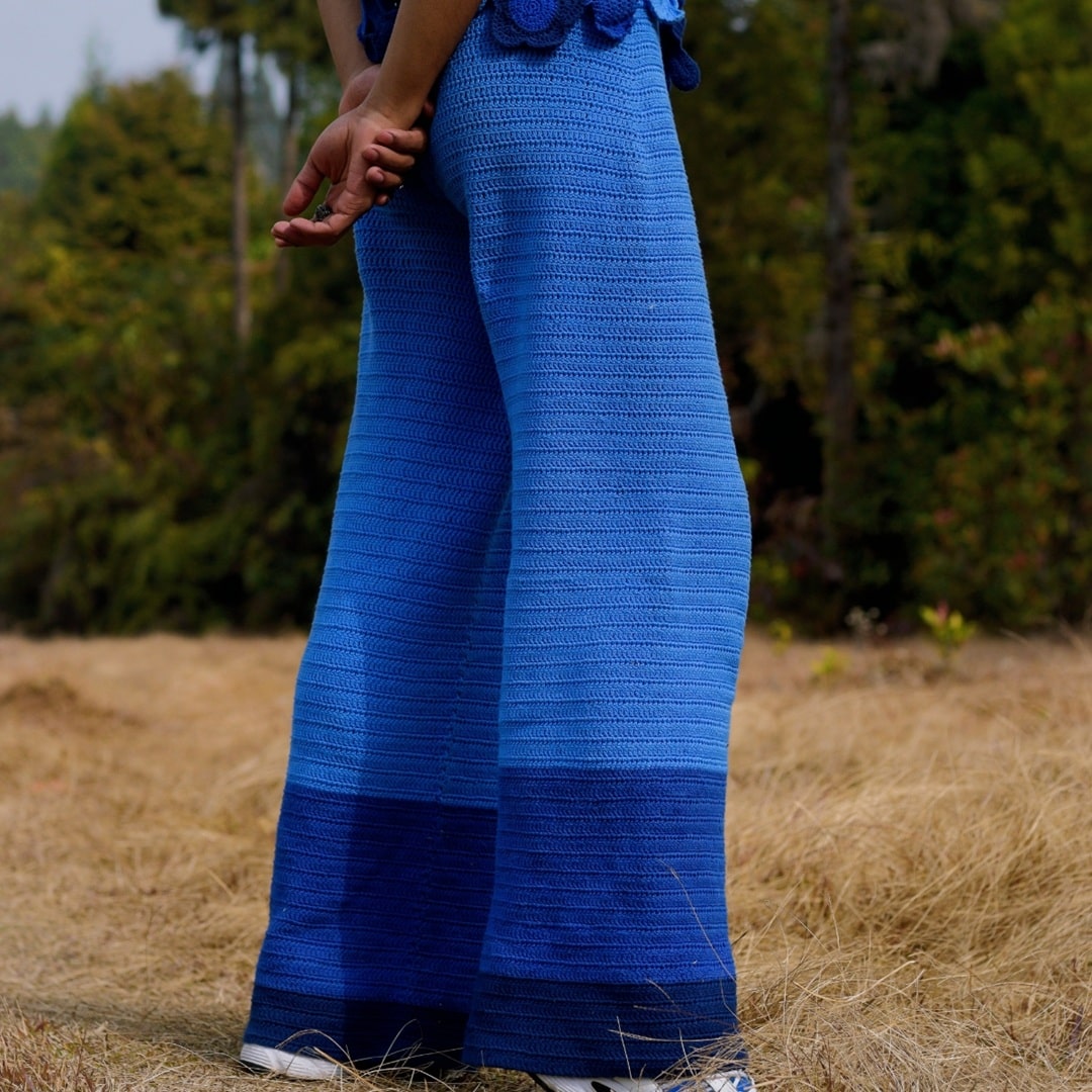 Side view of Sapphire crochet pants – monochromatic straight-fit design.