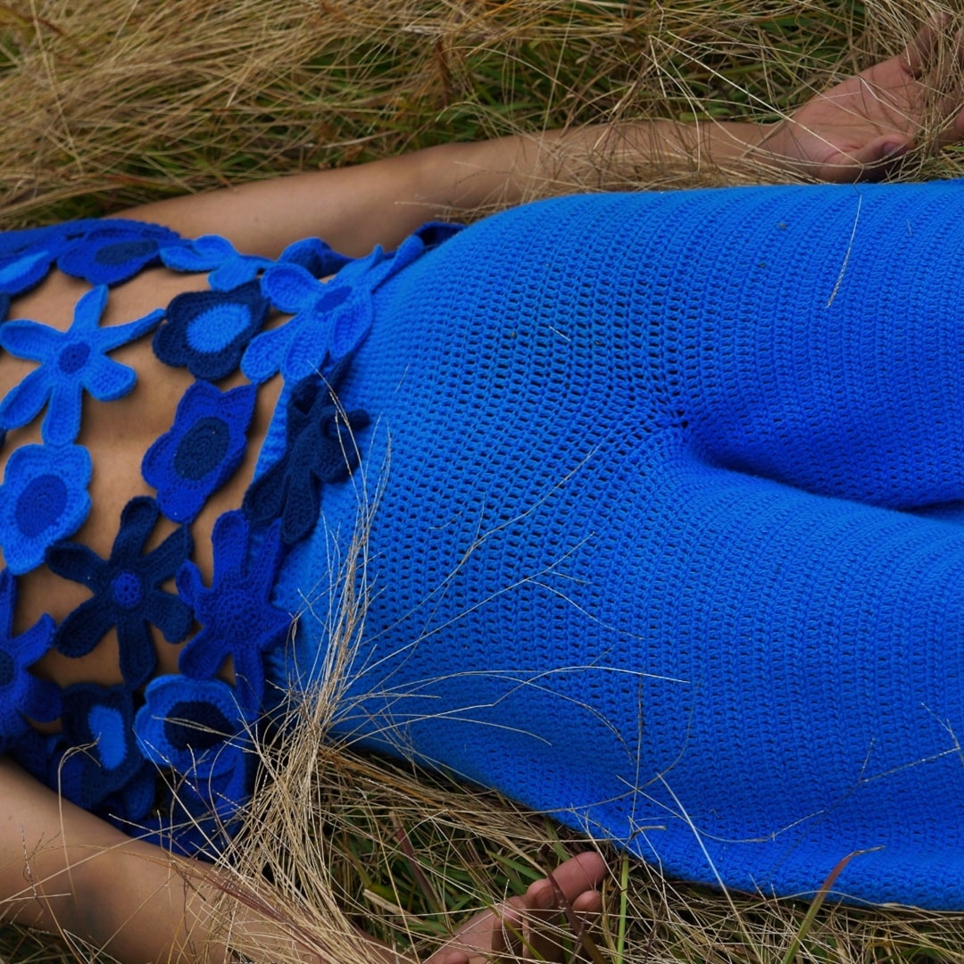 Model lying down in Sapphire crochet pants – boho and relaxed fashion.